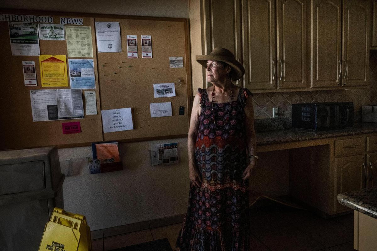 Maria Ruiz stands inside the clubhouse at Capital Mobile Estates last month. She said the new management has made residents feel unwelcome in their clubhouse by putting locks on the kitchen cabinets and accusing some of stealing coffee and sugar. Ruiz was given an eviction warning for hosting a guest with a pet and bringing her small dog into the clubhouse.