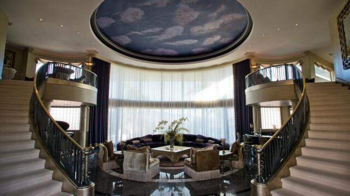  The main living room of Hollywood star Eddie Murphy’s former home in Granite Bay has a cloud-inspired ceiling. The home occupies the highest point in one of the region’s most exclusive enclaves, with sweeping views of Folsom Lake and the Sierra Nevada, below. 
