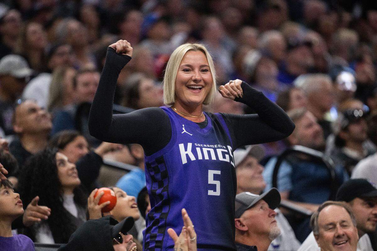 A fan wearing Sacramento Kings guard De’Aaron Fox (5) jersey flexes her muscles during a game against the Portland Trail Blazers at Golden 1 Center in October.