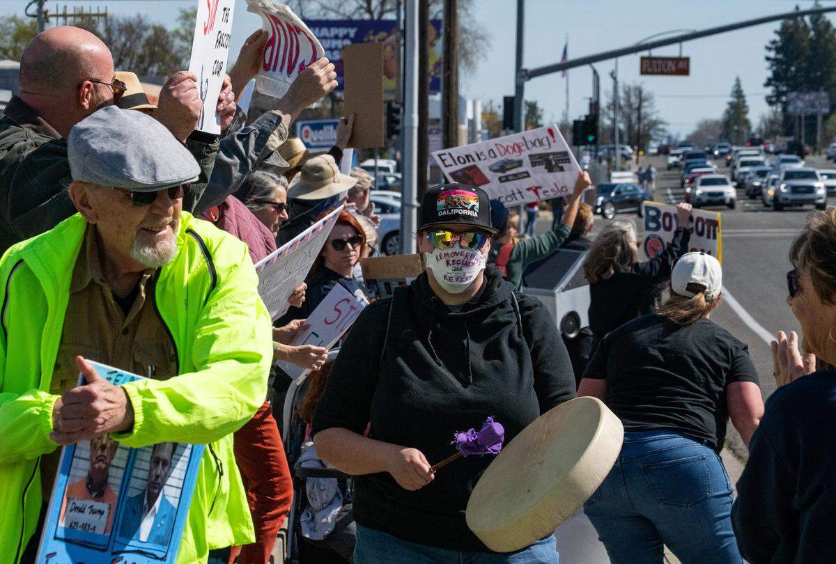 Demonstrators rally against Elon Musk at a Tesla dealership on Arden Way near Sacramento on Saturday, March 8, 2025. More than 100 people lined both sides of street to protest the role of the tech billionaire and Tesla CEO in the Trump administration.
