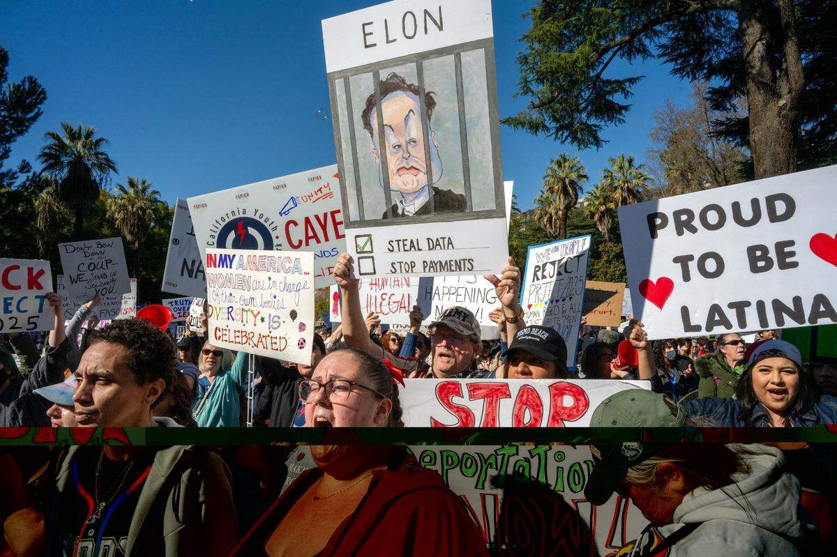 Ashely Gurich, center, of Oakland joins hundreds of demonstrators at a protest against President Donald Trump and his adviser Elon Musk at the California Capitol on Wednesday, Feb. 5, 2025.