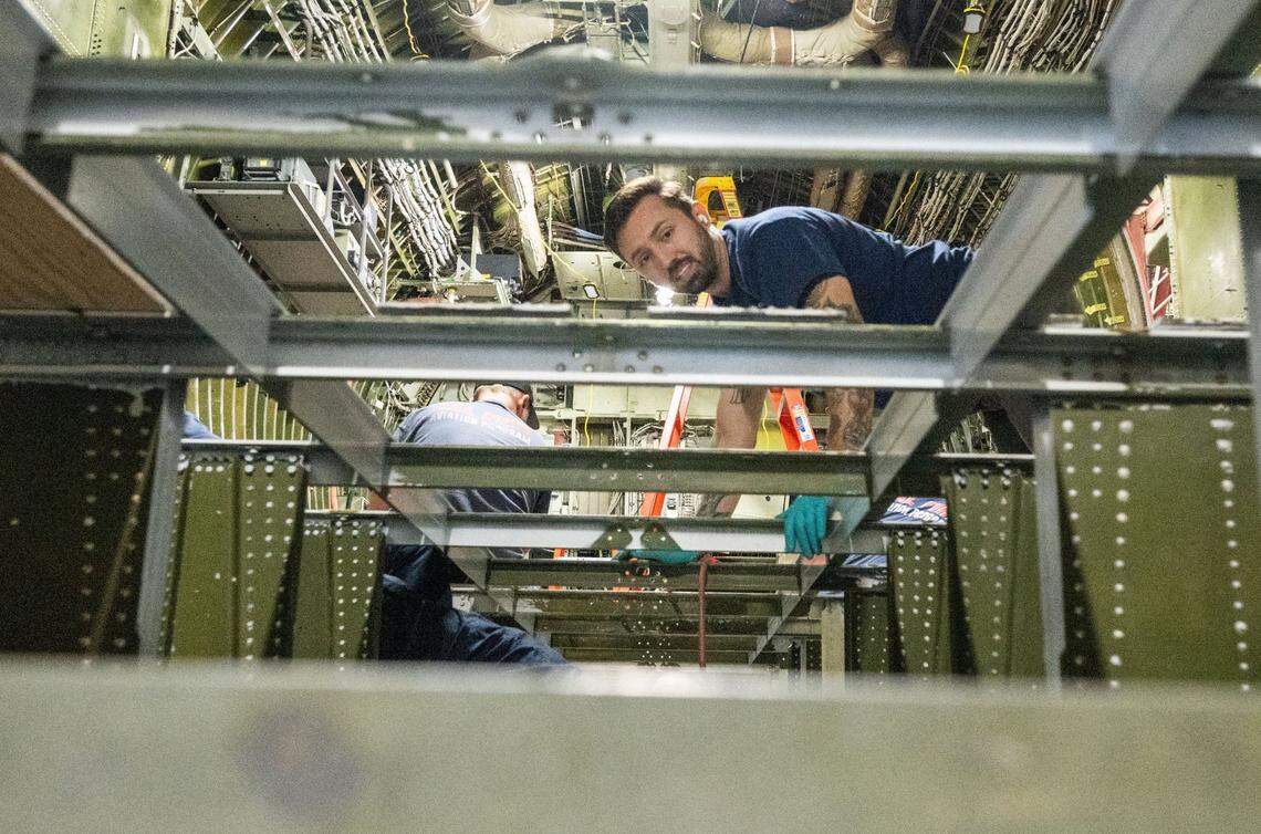 A Cal Fire worker sands the frame that will hold a 4,000 gallon tank on one of the C-130H air tankers on Thursday at McClellan Airport.