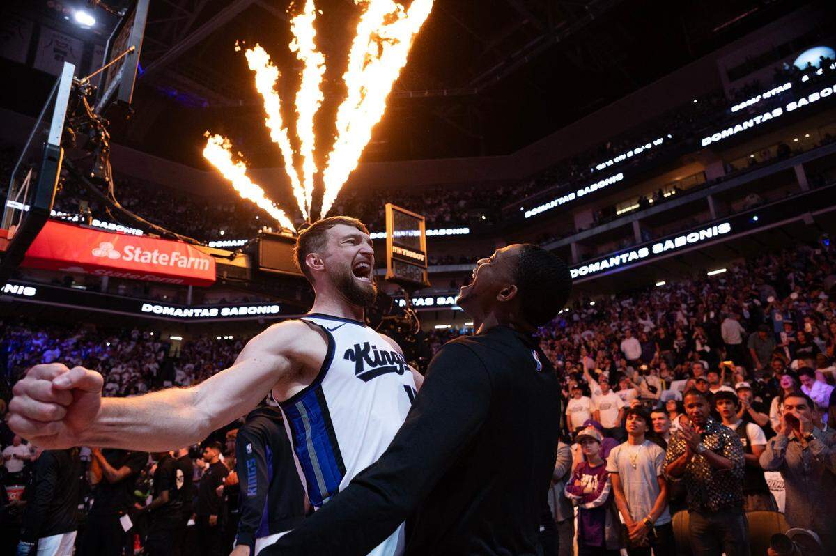 Sacramento Kings guard De’Aaron Fox and center Domantas Sabonis (10) chest bump before an NBA play-in game at Golden 1 Center on April 16.