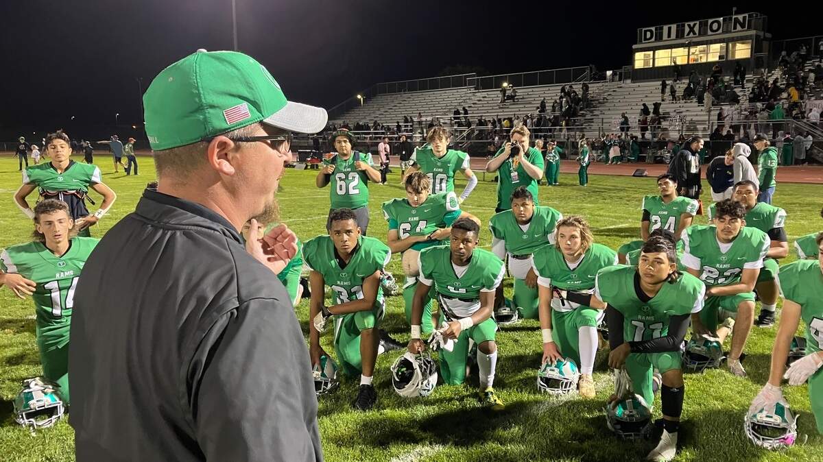 Dixon Rams coach Wes Besseghini congratulates his team after they beat Pioneer 21-18 to move to 7-1 Friday, Oct. 13, 2022.