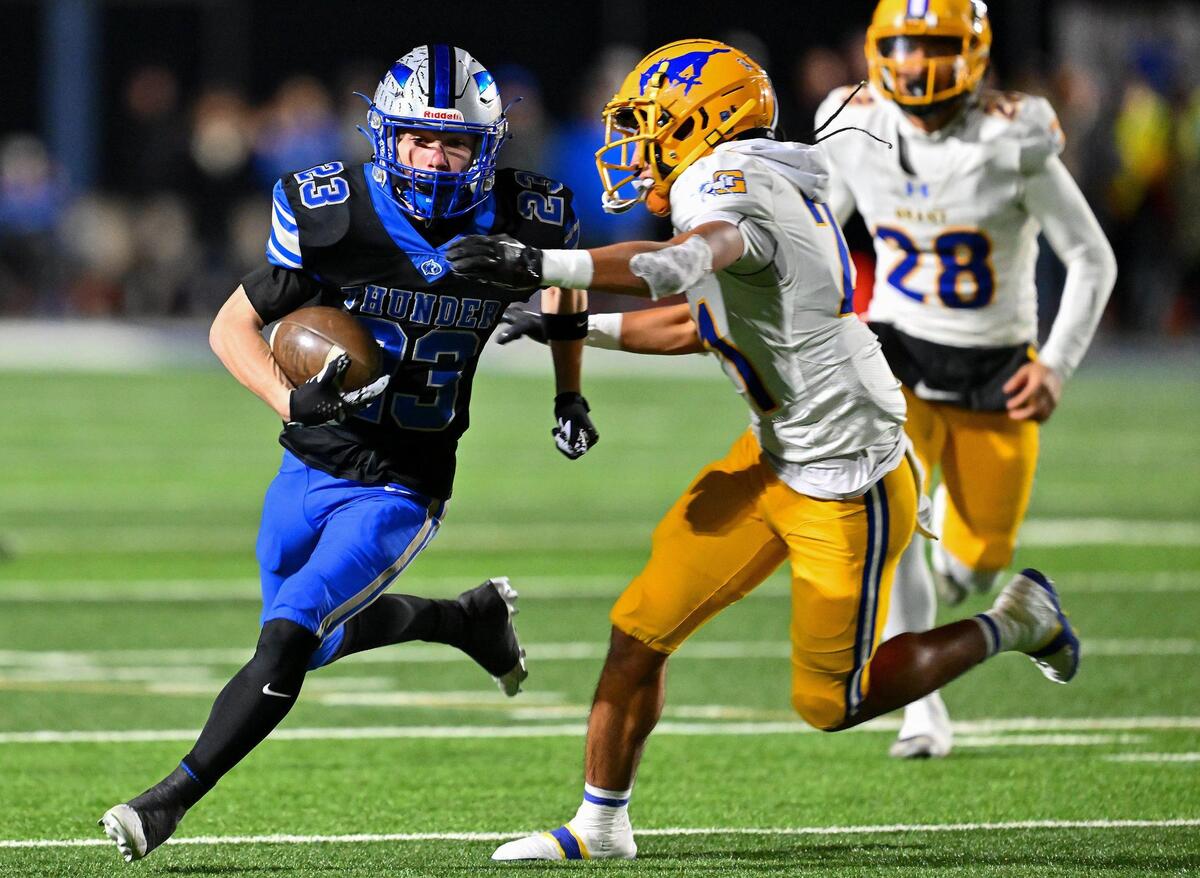 Rocklin Thunder Nate Martin (23) runs the ball for a first down before being tackled by Grant Pacers Solomona Malae (21) in the first half of the CIF Northern California Division 2-AA championship on Friday.