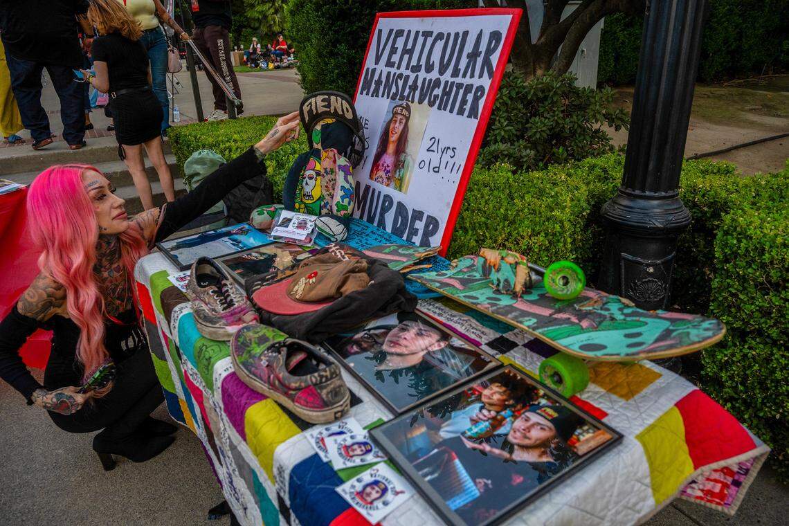 Erika Pringle straightens a hat on display alongside other belongings of her brother Andrew Pringle, including the broken skateboard he was riding when struck by a vehicle that ran a red light, at a National Day of Remembrance for homicide victims at the state Capitol in Sacramento on Thursday, Sept. 25, 2025, where she also spoke. She will host an event for vehicular homicide on Sunday, Nov. 16.