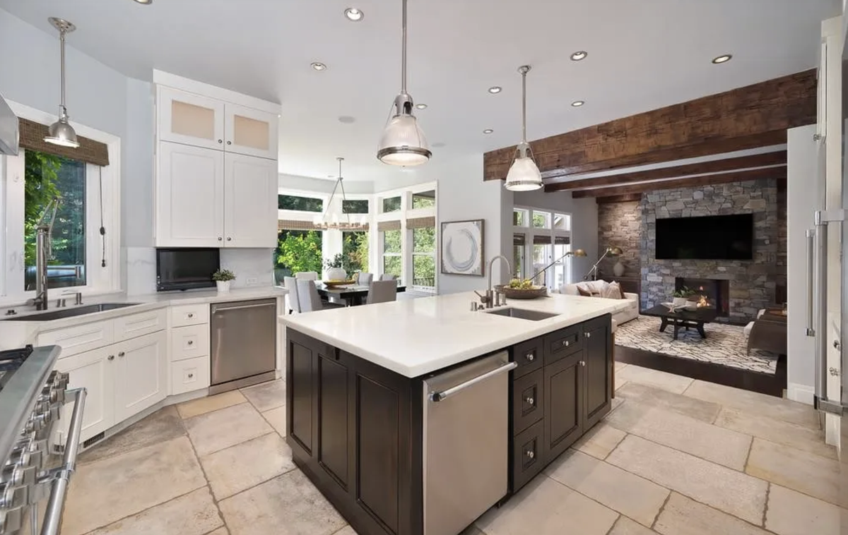 Sunlit and sophisticated, the gourmet kitchen features Carrara marble counters and a light-filled breakfast nook.