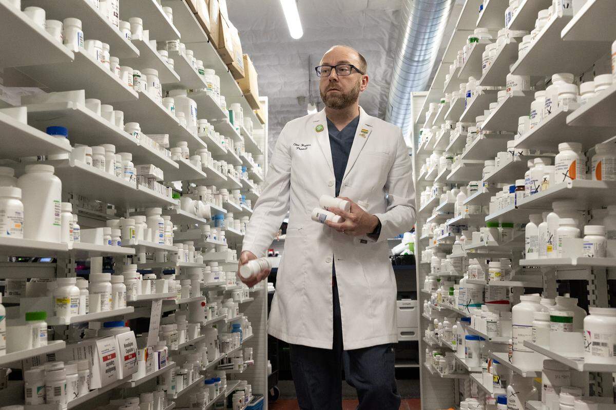 Pucci’s Pharmacy pharmacist and CEO Clint Hopkins stocks shelves with medications on Friday, Nov. 14, 2025, in Sacramento. California recently passed legislation restricting pharmacy benefit managers, a move intended to help small, independent pharmacies like his stay open.