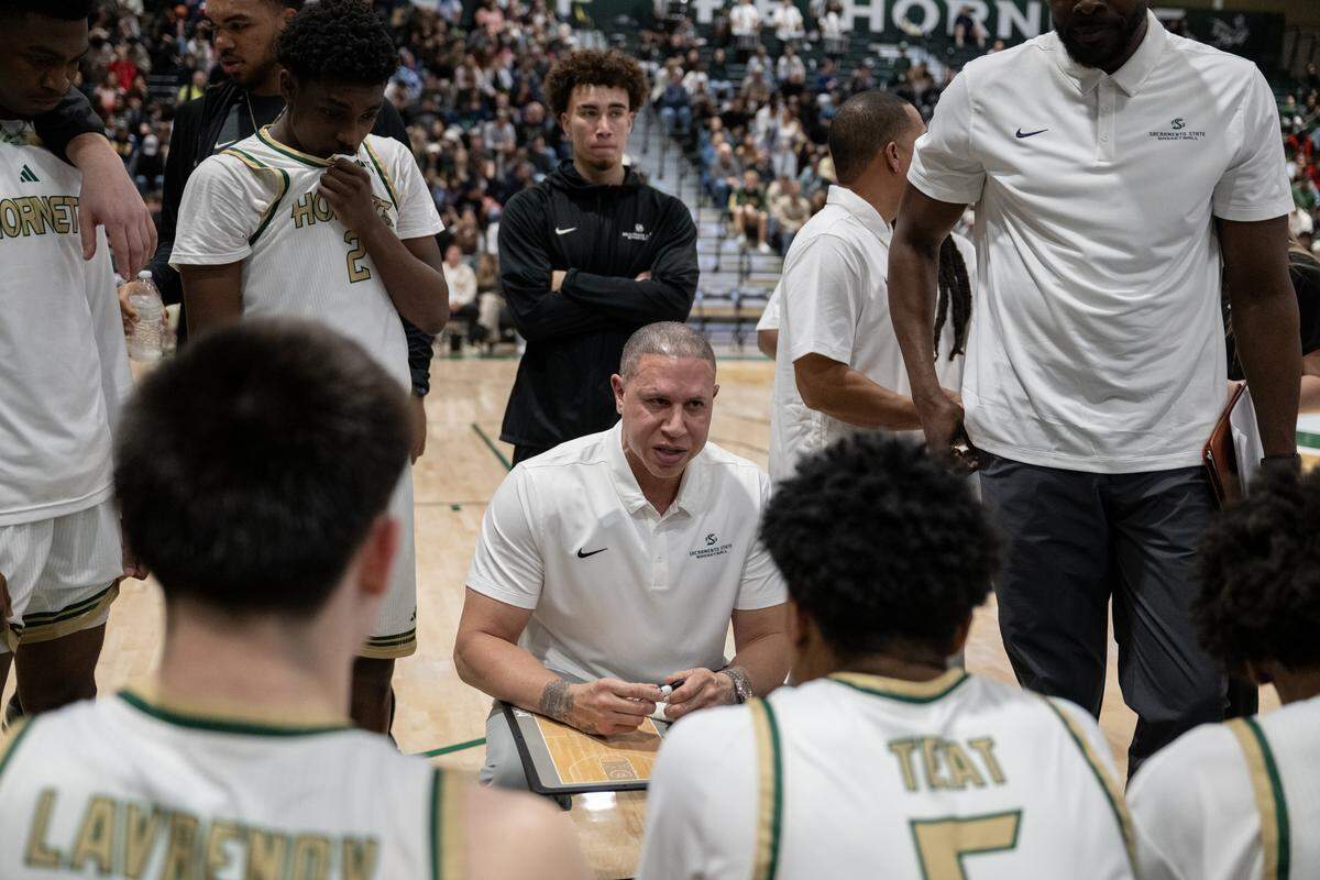 Sacramento State Hornets coach Mike Bibby talks with his team during a timeout in the second half on Thursday in Sacramento.