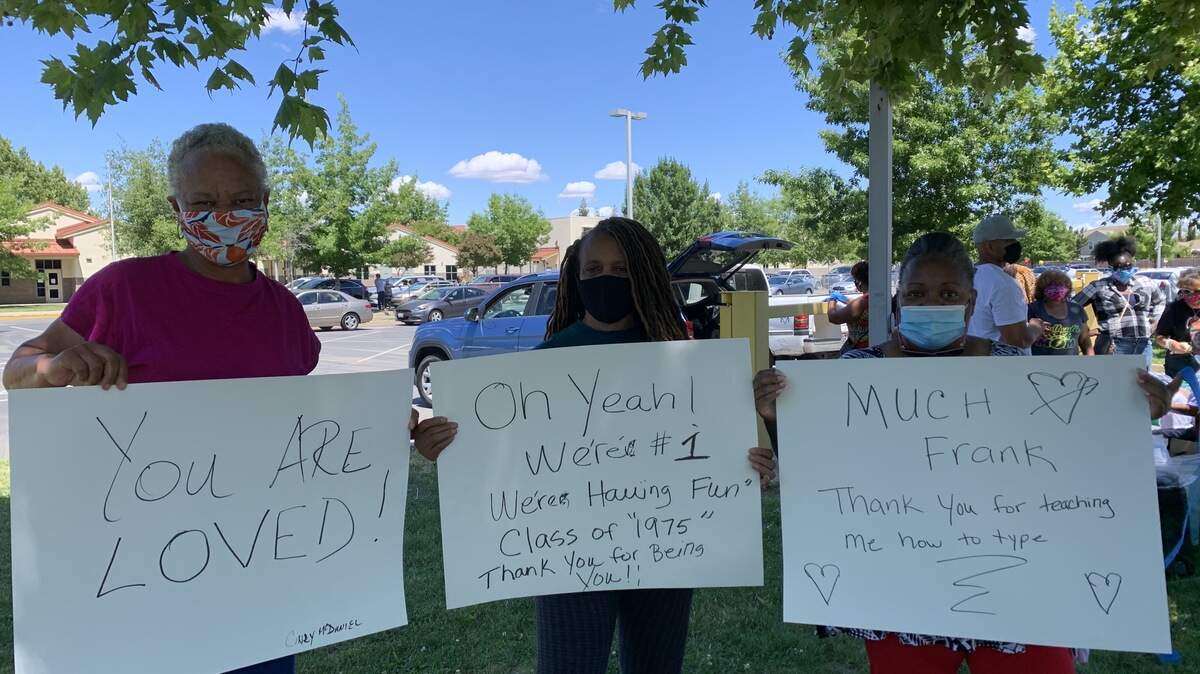 Former students of Withrow’s holding their messages of support