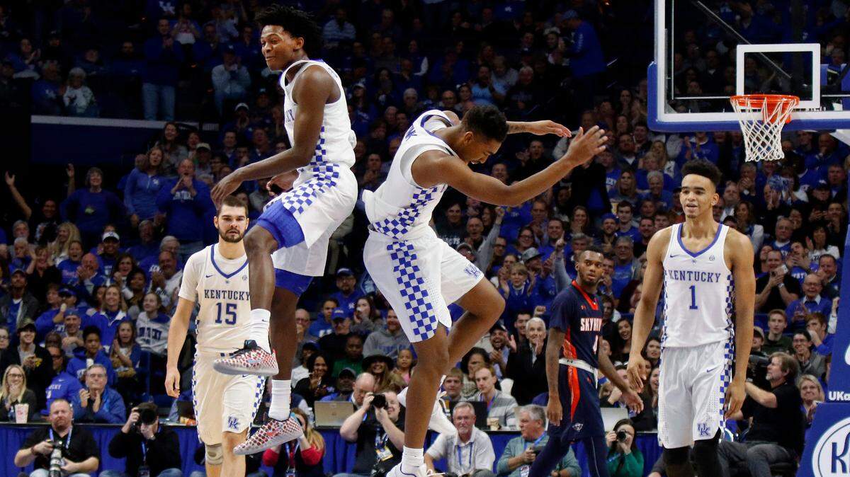 Kentucky’s De’Aaron Fox, top left, and Malik Monk, top right, celebrate prior to a time-out as Isaac Humphries (15) and Sacha Killeya-Jones (1) walk off the court during the second half of an NCAA college basketball game against Tennessee-Martin, Friday, Nov. 25, 2016, in Lexington, Ky. Kentucky won 111-76. (AP Photo/James Crisp)