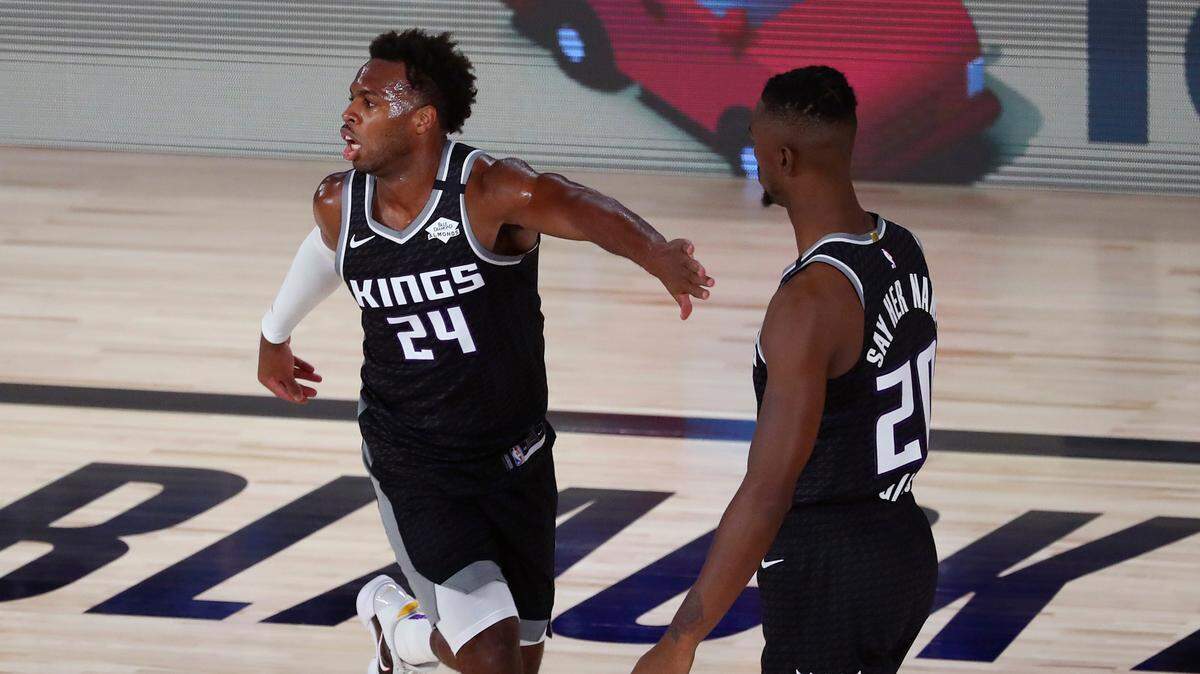 Sacramento Kings guard Buddy Hield celebrates with center Harry Giles after scoring against the Dallas Mavericks in the first half Tuesday.