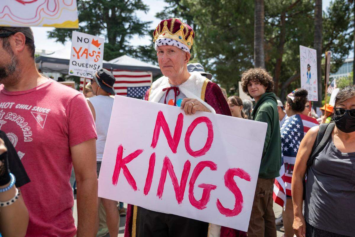 Mike Boyce, dressed as a king, protests near the state Capitol during the “No Kings” protest against the Trump administration in downtown Sacramento on Saturday.