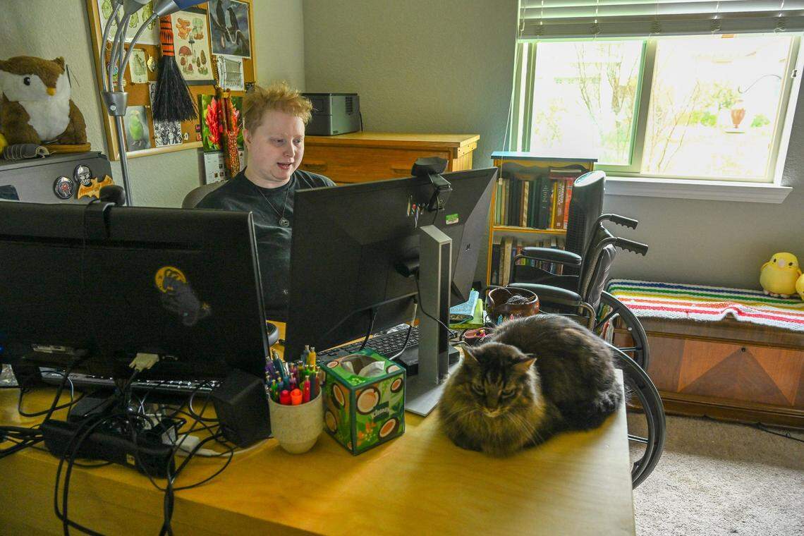 Evan Underwood sits in his home office in Woodland last month. His body temperature can’t go over 70 degrees and he can only walk short distances and depends on a wheelchair.