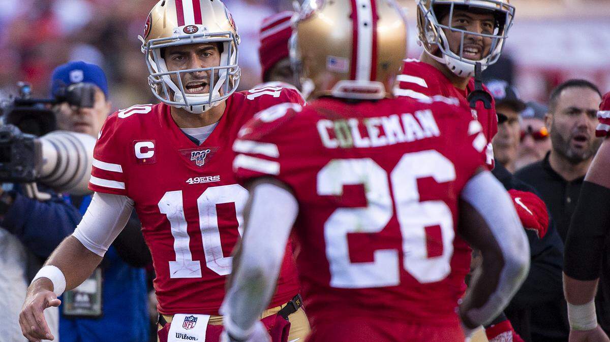 San Francisco 49ers quarterback Jimmy Garoppolo (10) congratulates San Francisco 49ers running back Tevin Coleman (26) after a touchdown in the third quarter during an NFC playoff game at the Levi’s Stadium on Saturday, Jan 11, 2020 in Santa Clara.