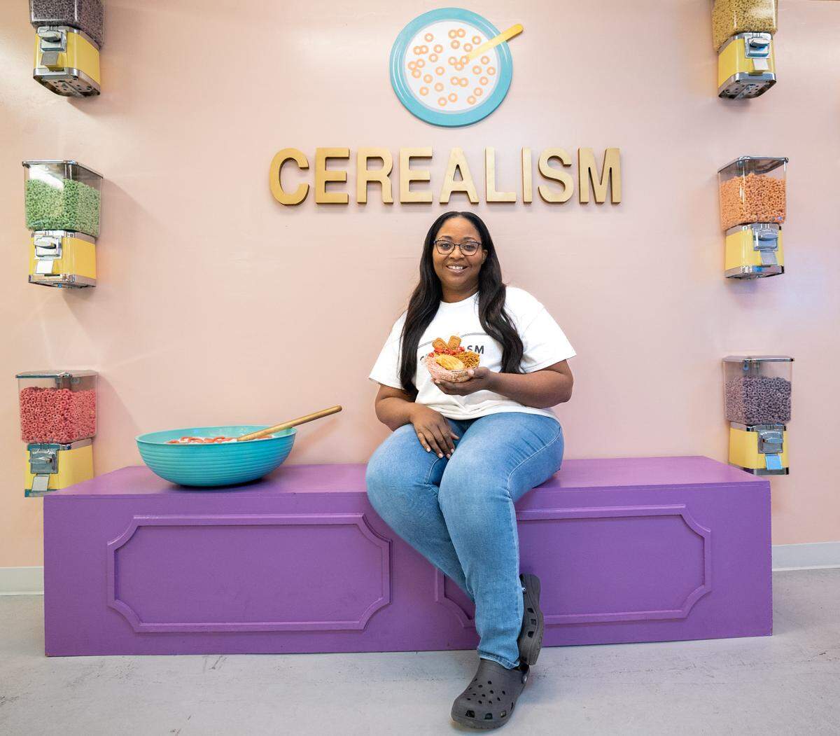 Laterica Reddix-Espinoza, the owner of Cerealism, poses at one of the cafe’s Instagrammable locations on Wednesday.