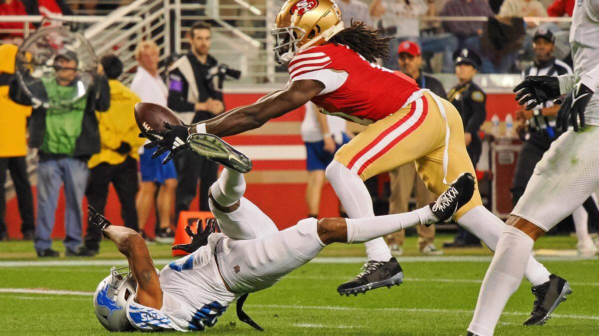 San Francisco 49ers wide receiver Brandon Aiyuk (11) catches a ball that bounced off the face mask of Detroit Lions cornerback Kindle Vildor (29) during the second half of the NFC Championship football game Jan. 28, 2024, at Levi’s Stadium in Santa Clara.