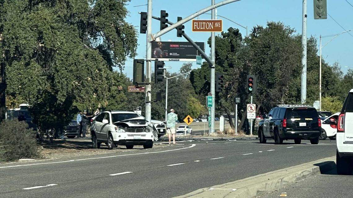 A damaged car sits on the shoulder of the intersection of Auburn Boulevard and Fulton Avenue in Arden Arcade on Tuesday after it was struck by a Sacramento Regional Transit Flex vehicle during a police chase.