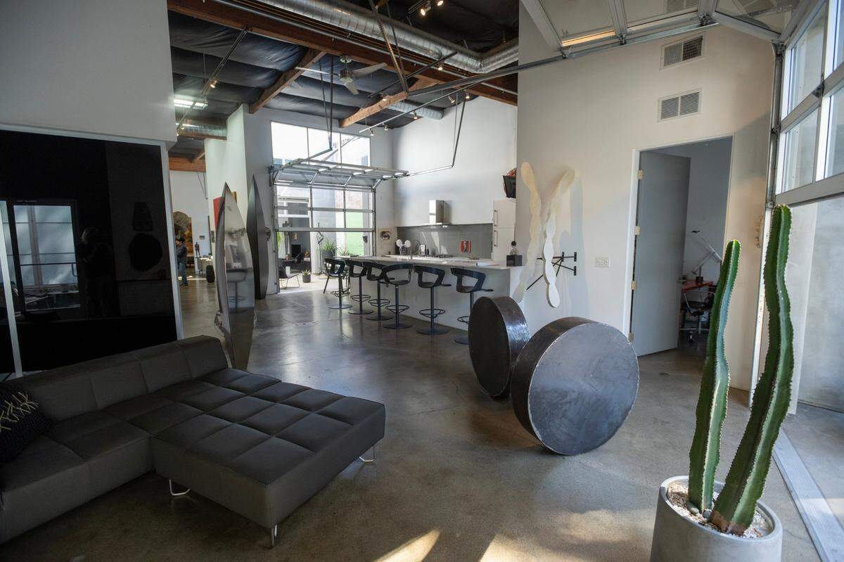 The open-concept kitchen in the former industrial space is seamlessly connected to the living spaces in the home.