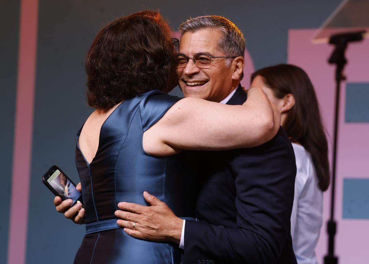 LOS ANGELES, CALIFORNIA - JUNE 02: Democratic Gubernatorial candidate Xavier Becerra (R) hugs his wife Carolina Reyes during his election night gathering at La Plaza de Cultura y Artes on June 02, 2026 in Los Angeles, California. Democratic Gubernatorial candidate Xavier Becerra will face Republican challenger Steve Hilton in the general election. (Photo by Justin Sullivan/Getty Images)