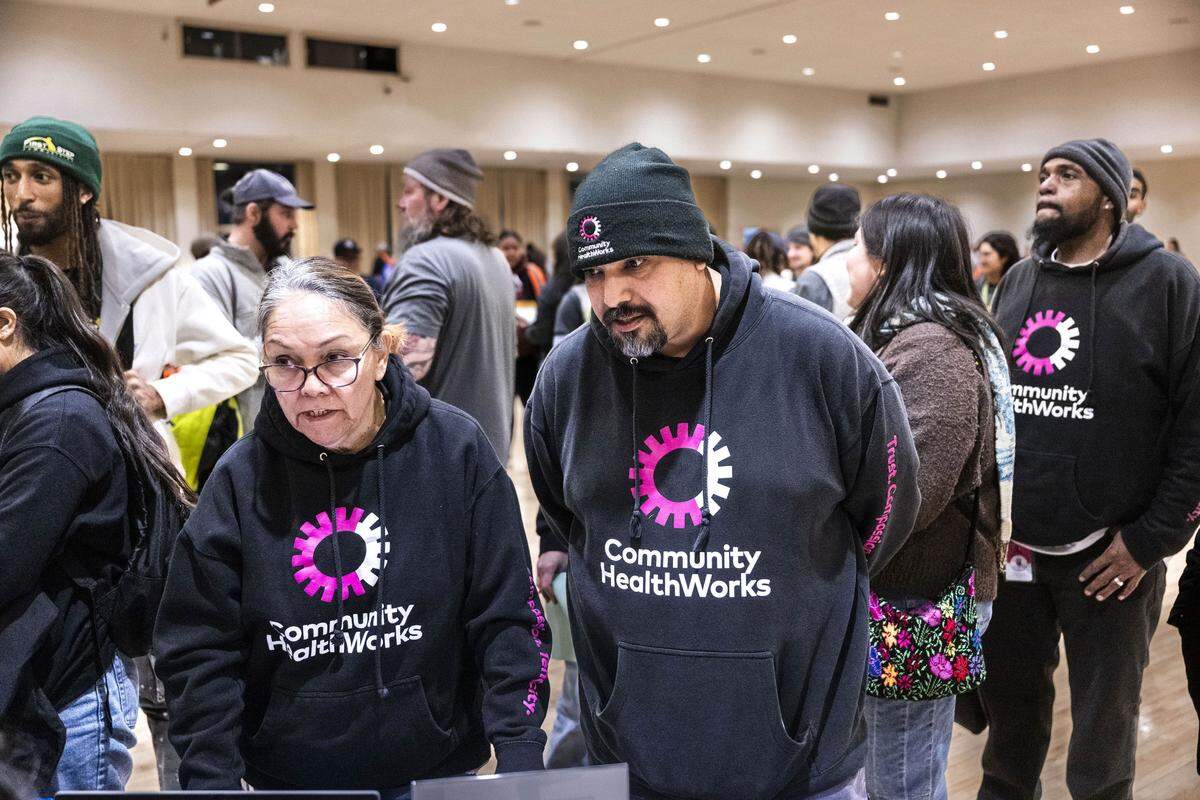 Jamie Valles and Nathan Aguilar, both with the nonprofit Community HealthWorks, get their assignment during the Sacramento County Point-in-Time homeless count at the Scottish Rite Masonic Center in Sacramento on Monday. The survey is conducted every two years to measure the number and demographics of the county's homeless population. 