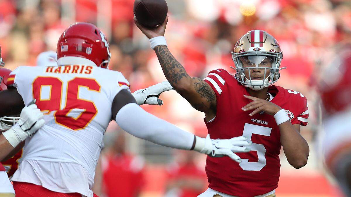 San Francisco quarterback Trey Lance throws under pressure from Kansas City Chiefs defensive end Demone Harris on Saturday, Aug. 14, 2021.
