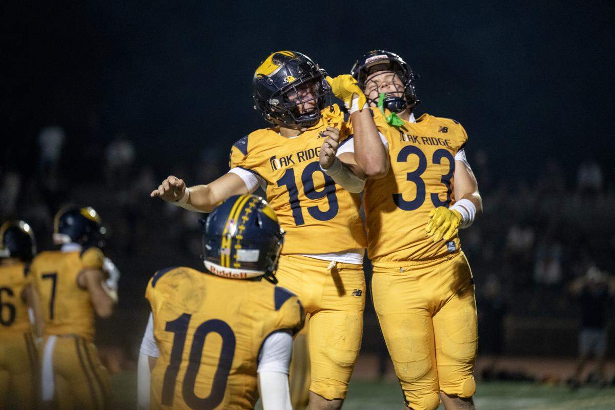 The Oak Ridge Trojans' Jonah Cedeno (19) celebrates with teammate Troy Taber (33) after Taber scored in the final moments of the first half on Friday in El Dorado Hills.
