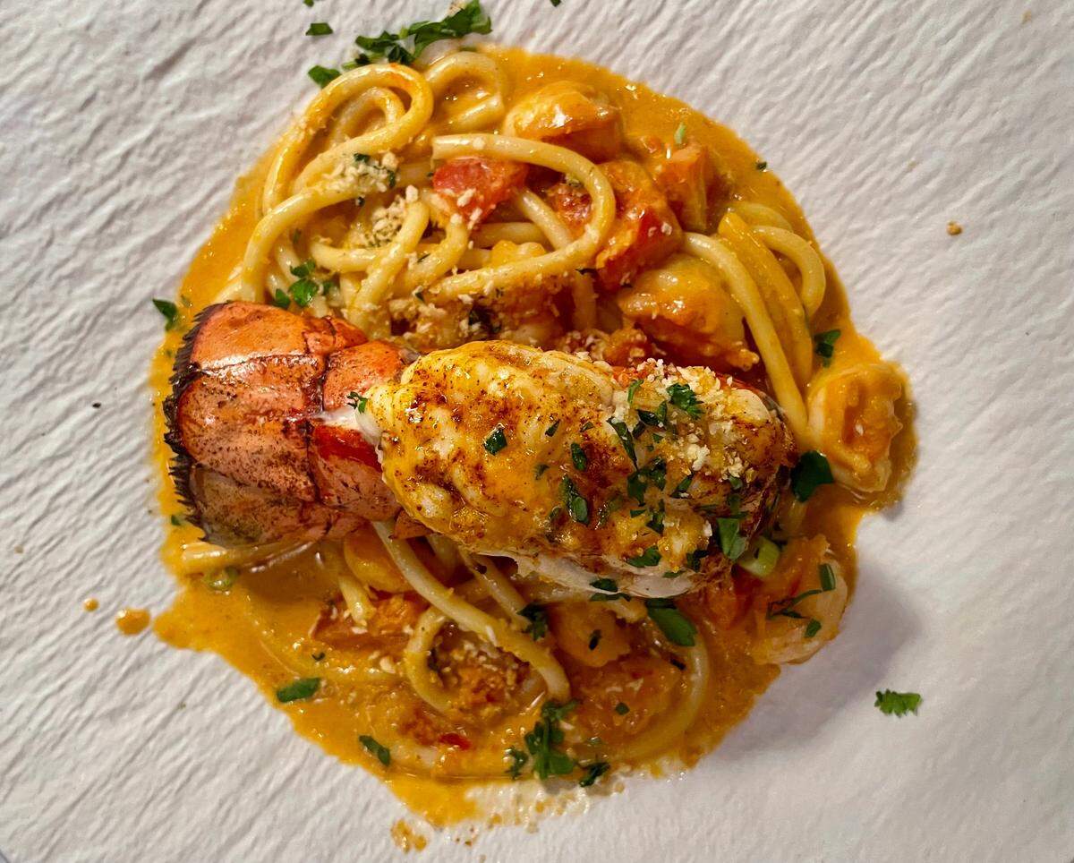 Rose Park Bistro’s lobster bucatini includes garlic-roasted tomatoes, shrimp and lemon breadcrumbs.