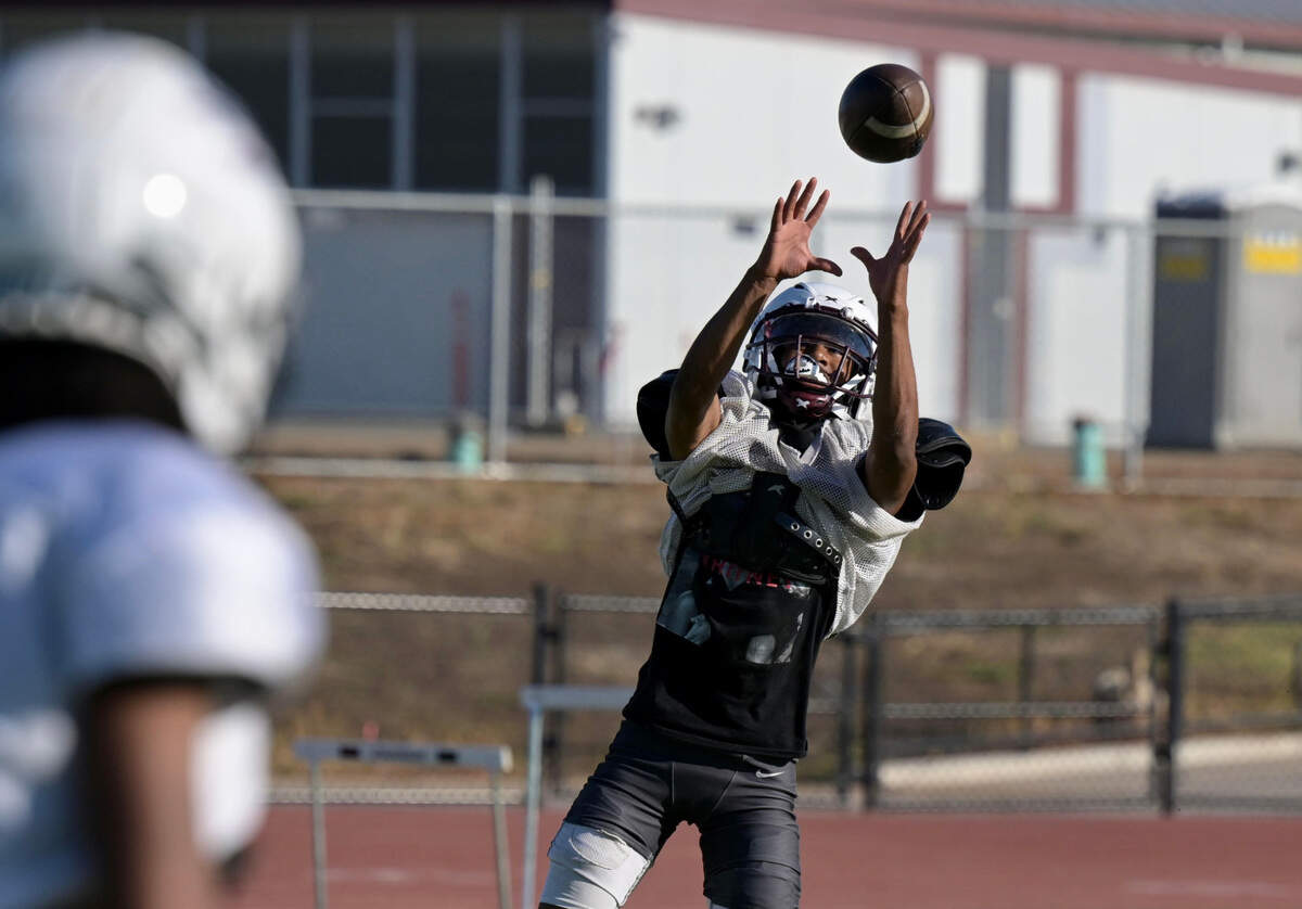 Hiram Johnson High School’s Jhayson Fowler — a multi-position football player who primarily plays at wide receiver, safety and quarterback — makes a catch at practice with his team Tuesday at the school in Sacramento.