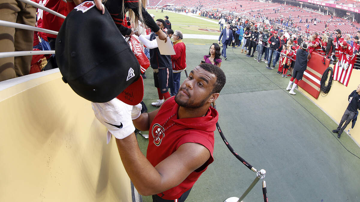 Arik Armstead signs autographs for fans before a game Nov. 12. The 49ers have to decide whether to bring back the defensive lineman.