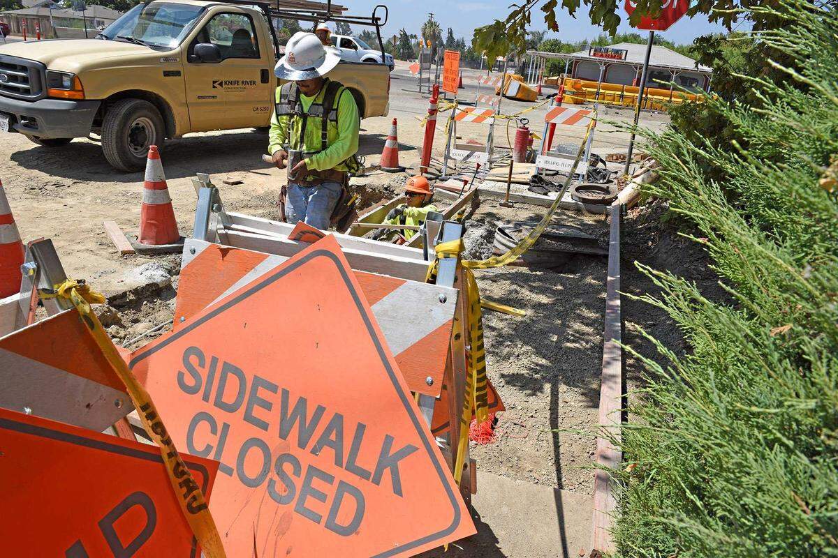 A construction worker builds a sidewalk on Chicago Avenue at Carpenter Road in Modesto in 2018. Dozens of pedestrian safety projects across California have remained unfunded after the state reduced support for the Active Transportation Program in 2024.
