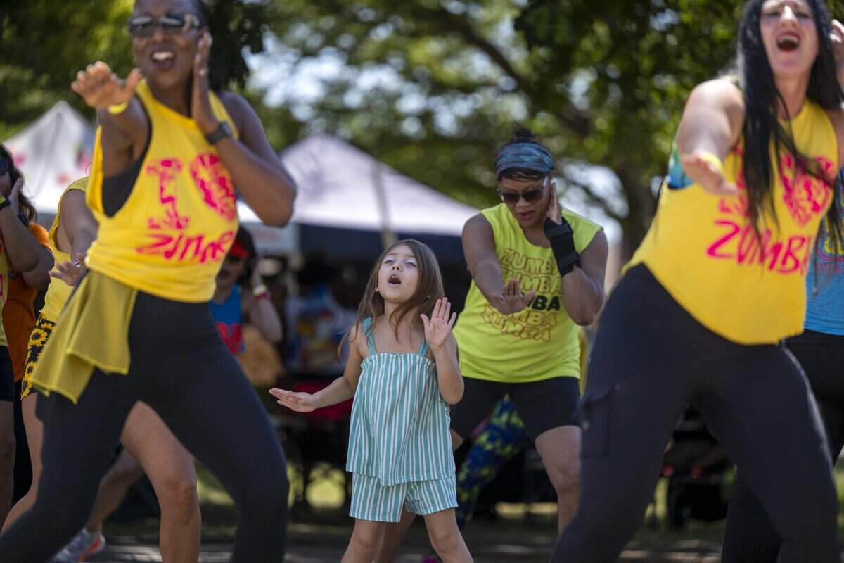 Emily T. dances with members of the Gloria and Friends Zumba group at the Banana Festival in Land Park on Saturday, Aug. 15, 2026.