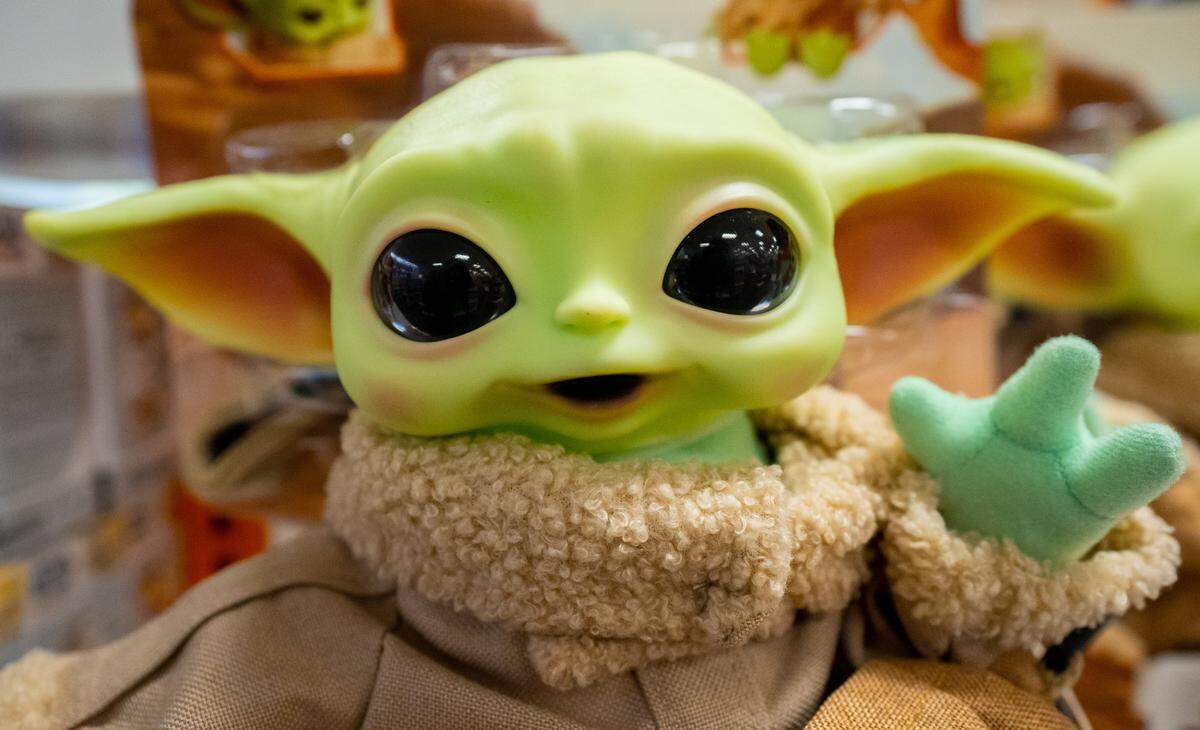A Baby Yoda doll is one of the many toys that fill the shelves of Macy’s Toys R Us section, August 9, 2022.