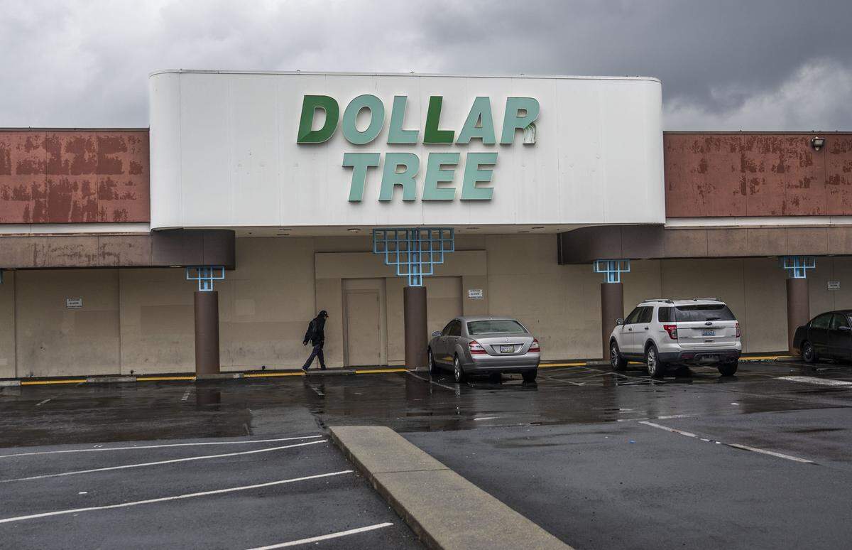 A pedestrian walks Wednesday by the Dollar Tree store on Stockton Boulevard in Sacramento that was once the Good Guys electronics store where a large hostage situation took place in April 1991.