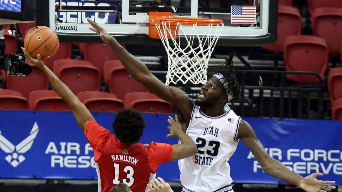 UNLV guard Bryce Hamilton (13) shoots as Utah State center Neemias Queta (23) defends during the first half of an NCAA college basketball game in the quarterfinals of the Mountain West Conference men’s tournament Thursday, March 11, 2021, in Las Vegas. (AP Photo/Isaac Brekken)