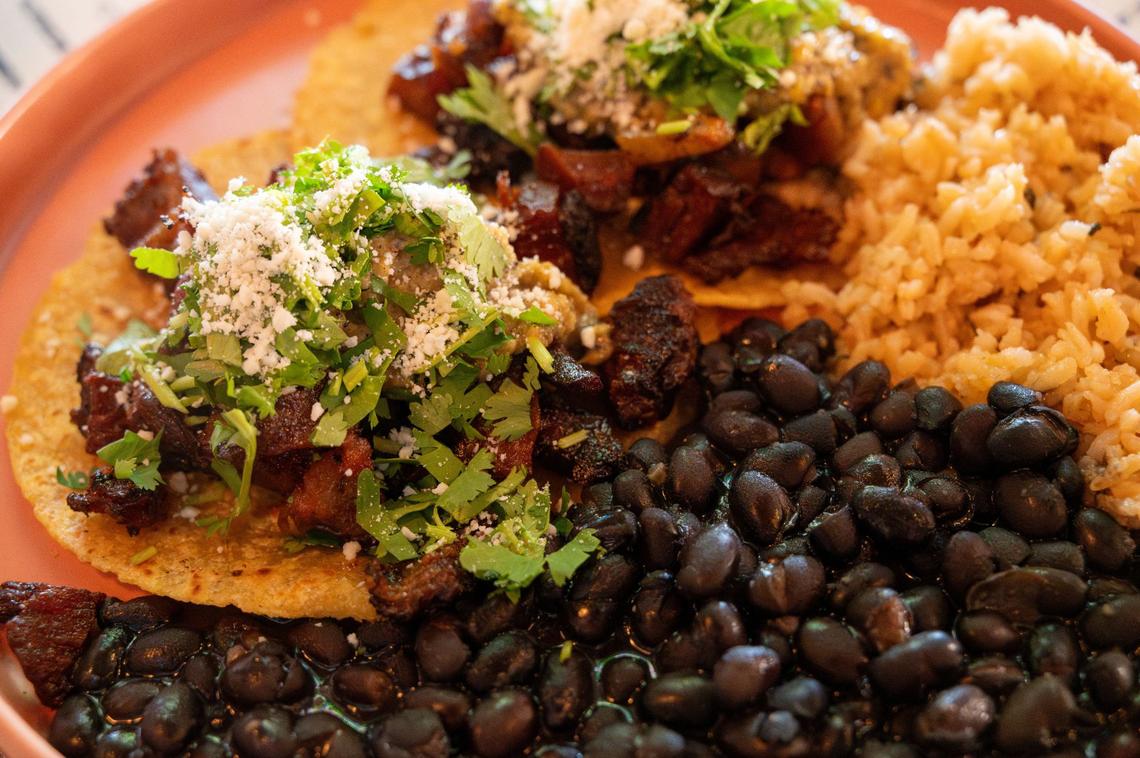 Pork belly tacos are available at Pig Latin in Elk Grove on Friday, July 19, 2024. Seared pork belly, mango habanero salsa and cojita on corn tortillas is served with rice and black beans.