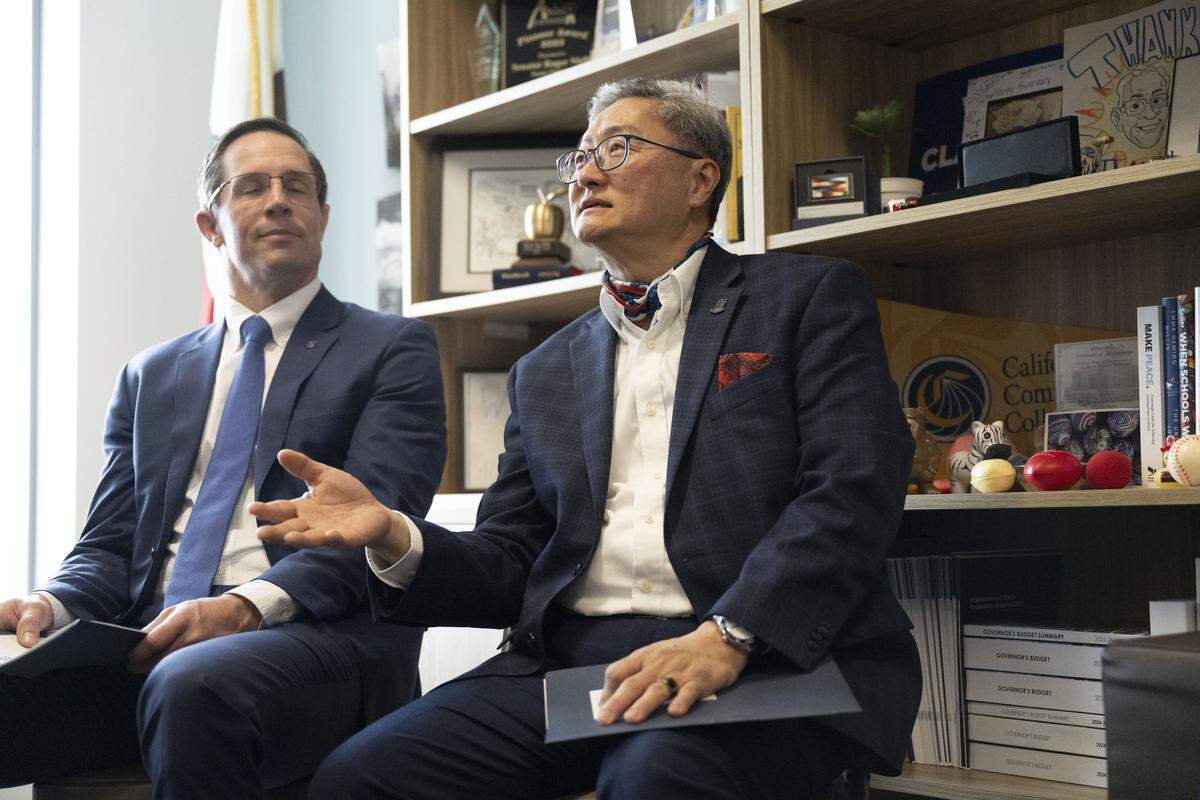 Steve Lee speaks with members of the Professional Engineers in California Government labor union about a telework bill at the Capitol Swing Space on Wednesday.