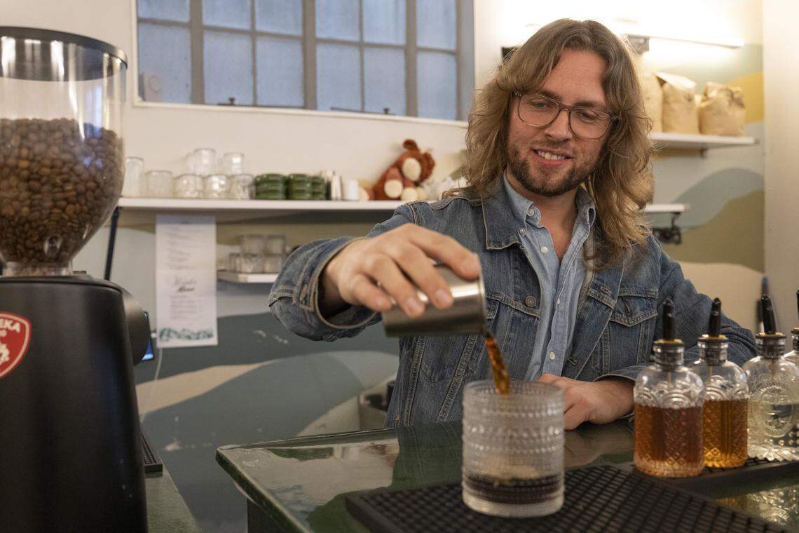Donovan Albert, co-founder of Anchor & Tree Coffee Roasting Company, makes a drink at the Sacramento coffee shop on Monday. Albert says Anchor & Tree is one of the only coffee shops in Sacramento using a Bellwether Coffee machine, which is an all-electric coffee roaster.