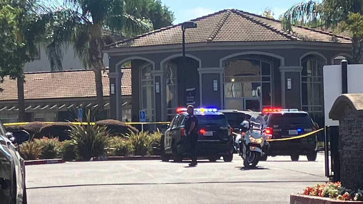 An officer stands watch Tuesday, Oct. 11, 2022, outside Bella Vista at Elk Grove Apartments on Di Lusso Drive following a shooting by Sacramento Police officers.