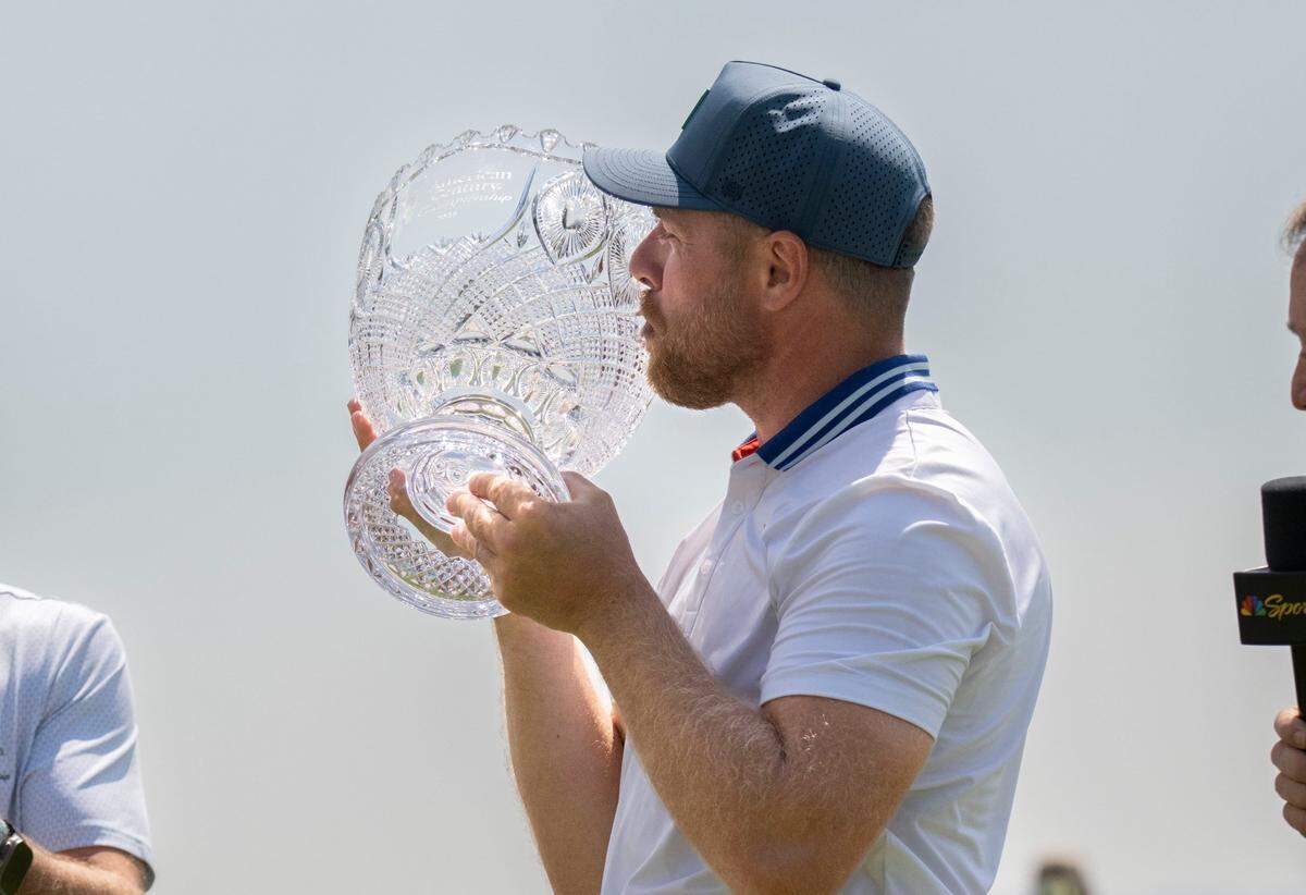Former NHL star Joe Pavelski kisses the champions trophy at the conclusion of the American Century Championship celebrity golf tournament at Edgewood Tahoe Resort in Stateline, Nev., on Sunday, July 13, 2025.