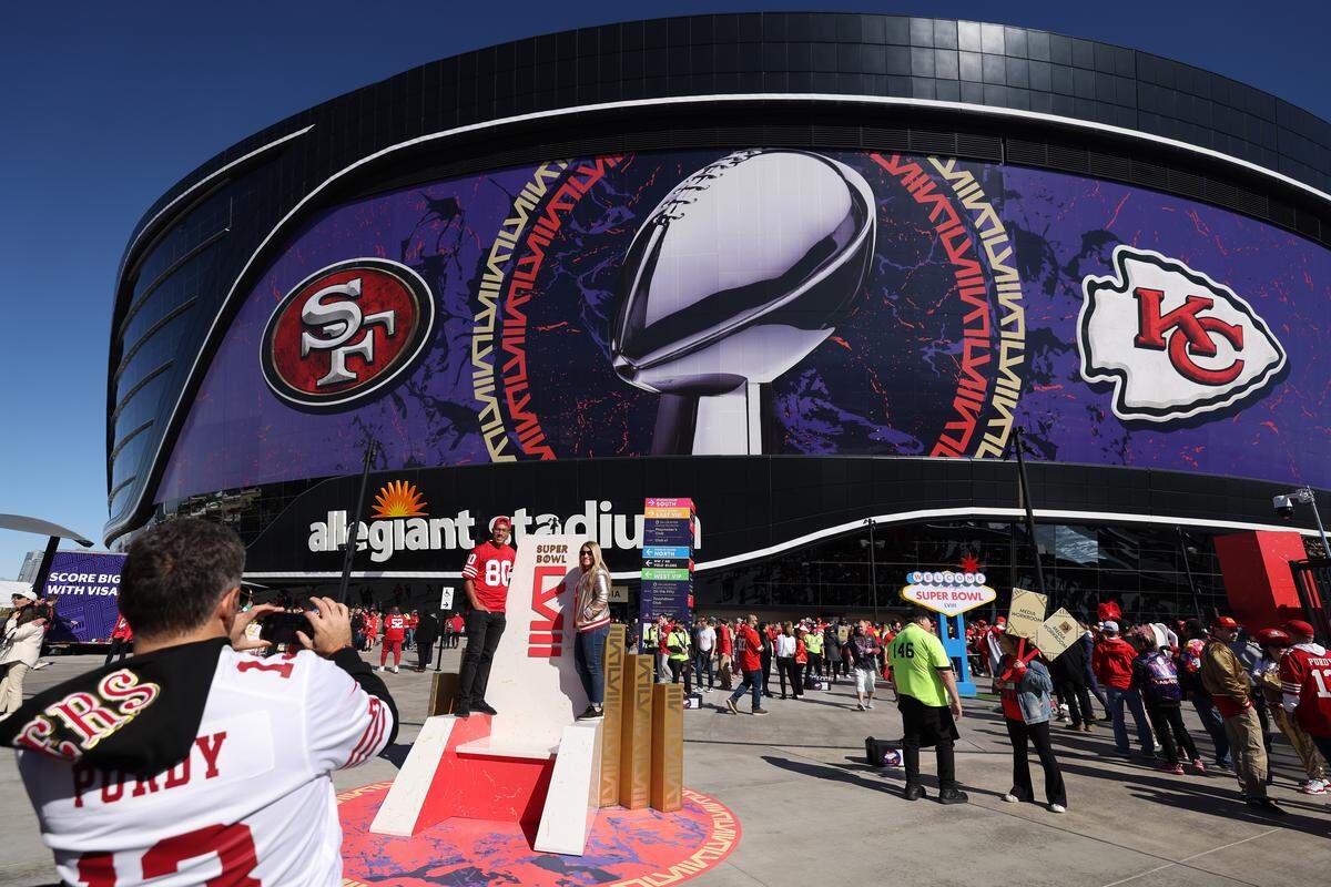 San Francisco 49ers fans pose for a photo outside of Allegiant Stadium prior to Super Bowl LVIII in February 2024 in Las Vegas.