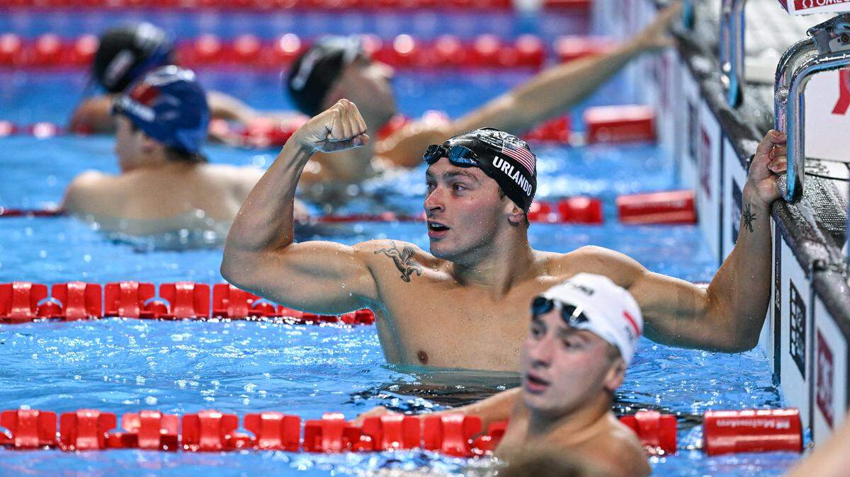 Winner US' swimmer Luca Urlando (top) and second-placed Poland's swimmer Krzysztof Chmielewski react after the final of the men's 200m butterfly swimming event during the 2025 World Aquatics Championships in Singapore on July 30, 2025. (Photo by Oli SCARFF / AFP via Getty Images)