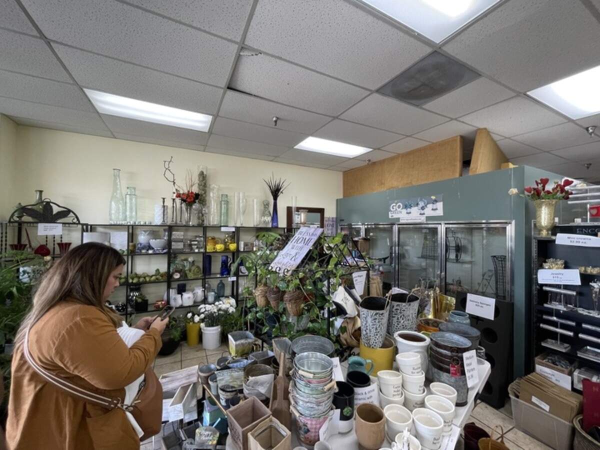 Elk Grove resident Alexis Limon checks her phone to see what items she might need for her DIY wedding while shopping at Laguna Flowers on Thursday, October 10, 2024.