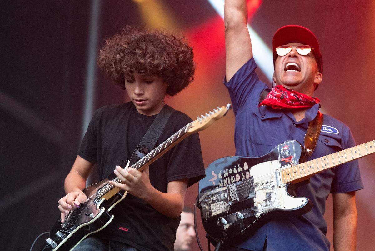 Roman Morello, left, plays a guitar solo while his father musician-activist Tom Morello, formerly of Rage Against the Machine, cheers during at the Aftershock festival in Sacramento’s Discovery Park on Sunday.