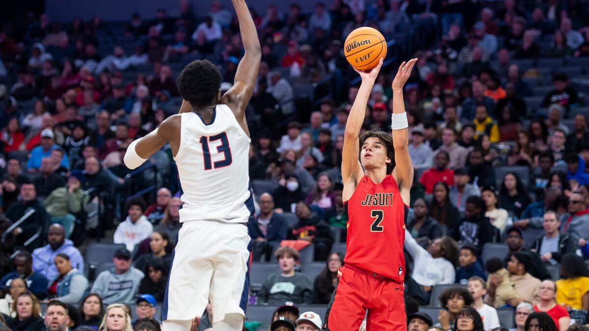 The Jesuit Marauders’ Andrej Stojakovic (2) shoots a 3-pointer over Modesto Christian Crusaders center Prince Oseya (13) in the CIF Sac-Joaquin Section Division I boys basketball championship on Saturday. Stojakovic had 17 points. The Crusaders won 79-53.