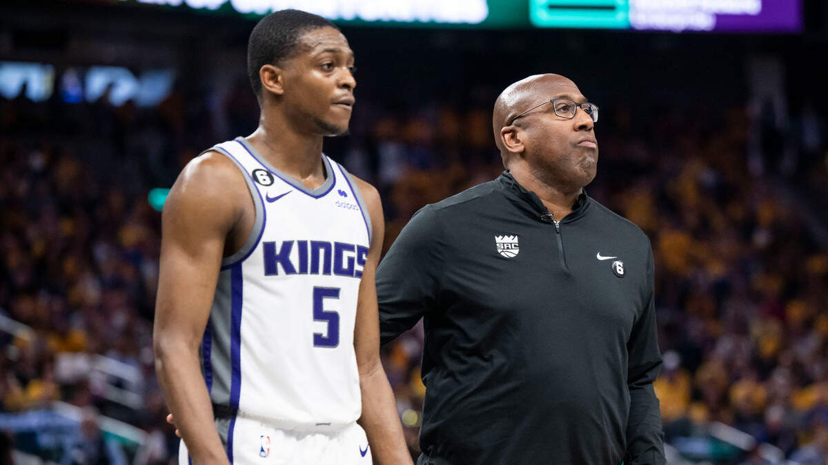 Sacramento Kings head coach Mike Brown puts his arm around guard De’Aaron Fox (5) as he heads in for a timeout during the second half against the Golden State Warriors in Game 3 of the first-round NBA playoff series at Chase Center in San Francisco on Thursday, April 20, 2023.