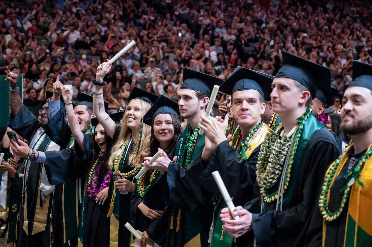 Graduates cheer during the Sacramento State College of Business commencement in 2023 at Golden 1 Center.