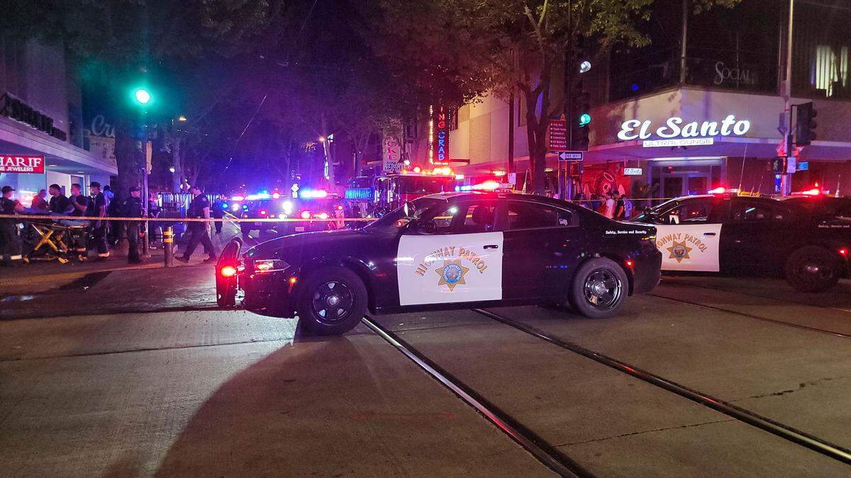 First responders treat victims at the scene of a mass shooting near the intersection of 10th and K streets in downtown Sacramento on Sunday, April 3, 2022.