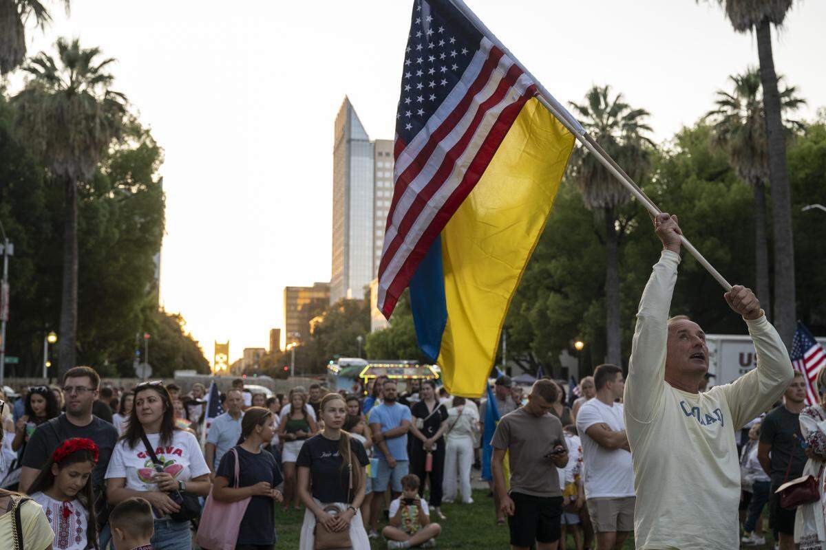 Ukrainian Americans wave Ukrainian and American flags during a Ukrainian Independence Day celebration at the California Capitol in Sacramento on Sunday.