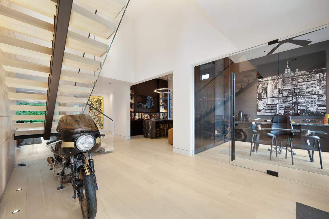 A Ducati motorcyle and floating staircase are wonderful focal points in the entry sequence.